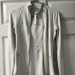 Lululemon cream colored jacket NWT .  Perfect condition. Smoke free..